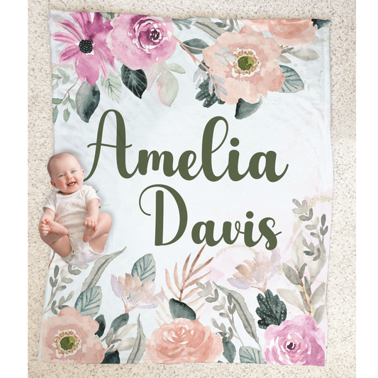 Baby girl laying on a personalized minky plush blanket featuring beautiful watercolor pink and dusty roses design.